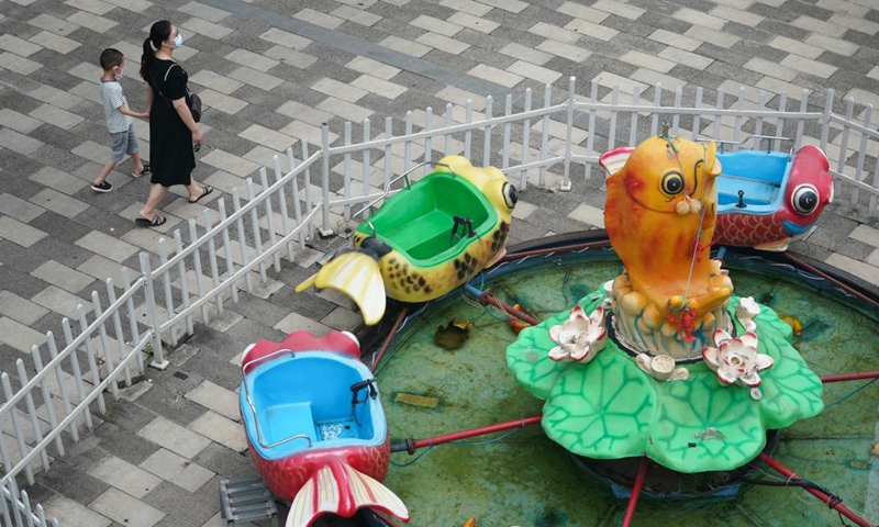 People walk at a commercial area in Lukou Subdistrict, Jiangning District of Nanjing, east China's Jiangsu Province, Aug. 26, 2021.Photo:Xinhua