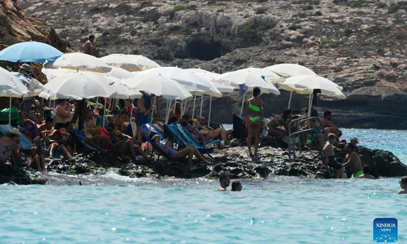 People enjoy summer around the Blue Lagoon of Comino, a small island in Malta, Aug. 26, 2021.Photo:Xinhua