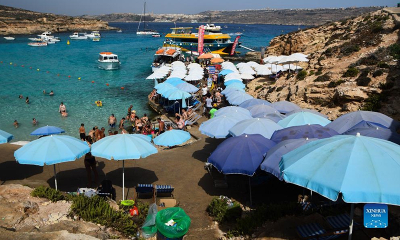 People enjoy summer around the Blue Lagoon of Comino, a small island in Malta, Aug. 26, 2021.Photo:Xinhua