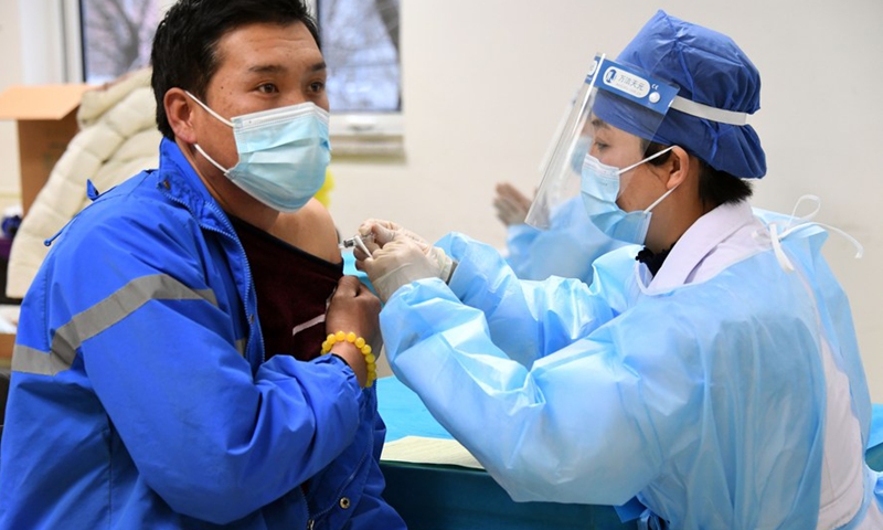 A medical worker inoculates a recipient with a COVID-19 vaccine at a temporary inoculation site in Haidian District in Beijing, capital of China, Jan 11, 2021.Photo:Xinhua