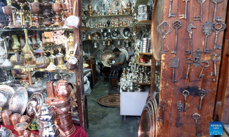 A coppersmith prepares products for customers at the Coppersmith Bazaar in Gaziantep, Turkey, Aug. 26, 2021.Photo:Xinhua