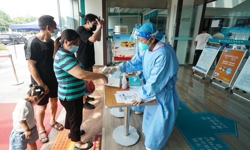 Residents have their body temperature checked at the entrance of a community hospital in Lukou Subdistrict, Jiangning District of Nanjing, east China's Jiangsu Province, Aug. 26, 2021.Photo:Xinhua