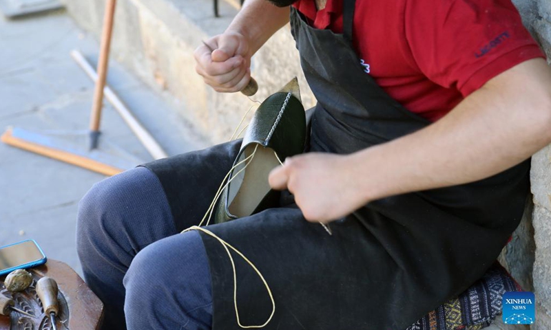 A shoemaker makes shoes at the Coppersmith Bazaar in Gaziantep, Turkey, Aug. 26, 2021.Photo:Xinhua