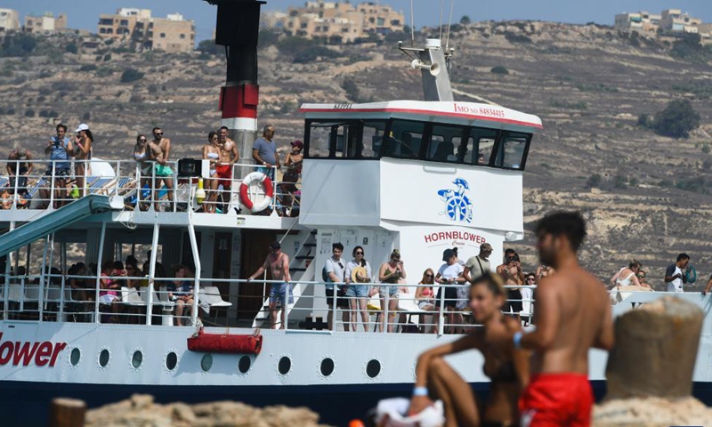 People enjoy summer around the Blue Lagoon of Comino, a small island in Malta, Aug. 26, 2021.Photo:Xinhua
