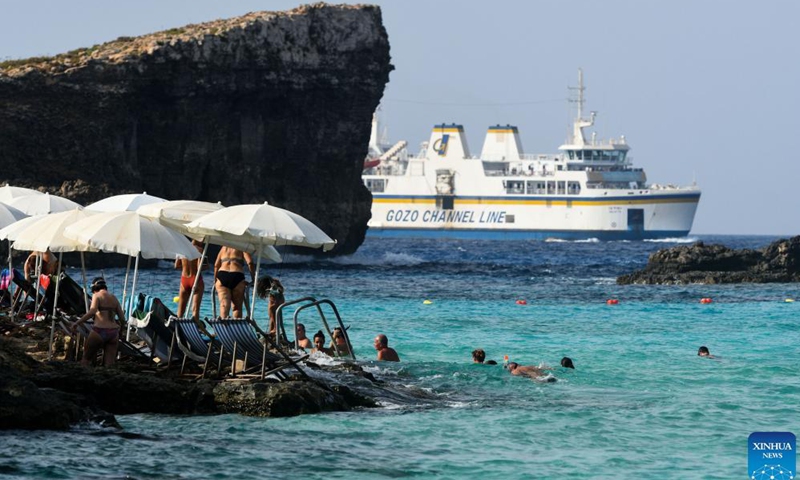 People enjoy summer around the Blue Lagoon of Comino, a small island in Malta, Aug. 26, 2021.Photo:Xinhua