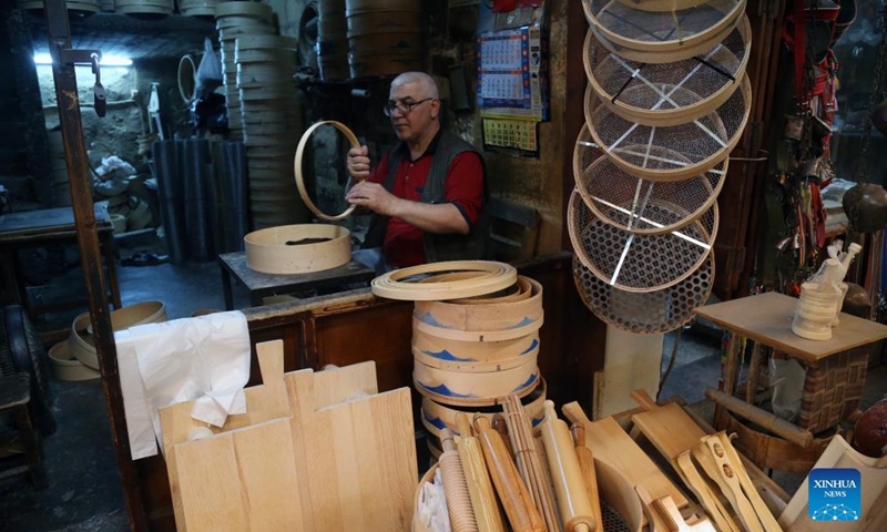 A sieve master prepares products for his customers at the Coppersmith Bazaar in Gaziantep, Turkey, Aug. 26, 2021.Photo:Xinhua