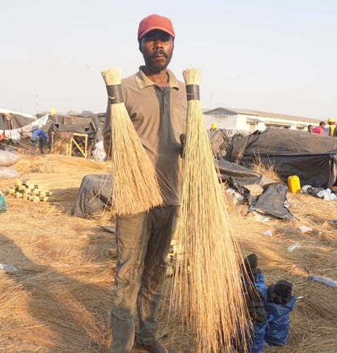 Kabunda Mwata, who specializes in making brooms made from wild grasses, poses for a photo in Lusaka, Zambia, on Aug. 20, 2021.Photo:Xinhua