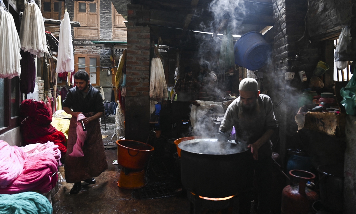 Artisans work to dye silk yarn at a workshop in Srinagar, Indian-controlled Kashmir on December 3, 2019. Photo: AFP