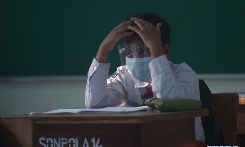 A student wearing protective gears attends a class at a school reopened after several months due to COVID-19 pandemic in Jakarta, Indonesia, Aug. 30, 2021. Photo:Xinhua