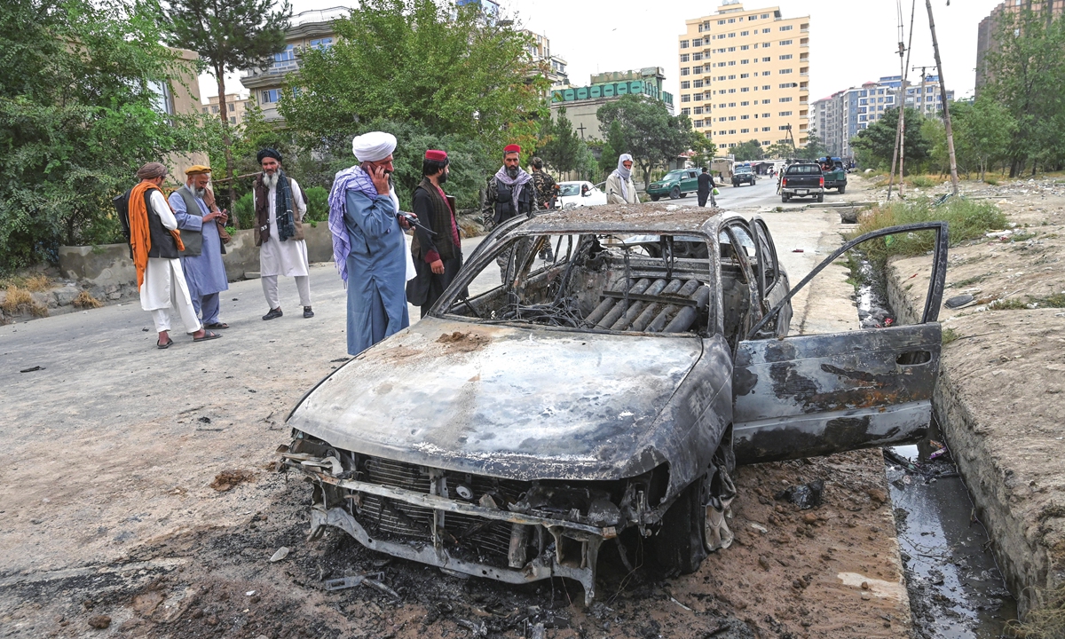 Taliban fighters investigate a damaged car after multiple rockets were fired in Kabul on Monday. Rockets flew across the Afghan capital on Monday as the US raced to complete its withdrawal from Afghanistan, with the evacuation of civilians all but over and terror attack fears high. Photo: AFP