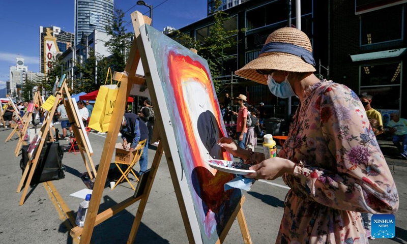 An artist works on her painting during the Art Masters painting competition in Vancouver, British Columbia, Canada, Aug. 29, 2021. The Art Masters is a painting competition with professional artists completing their works within one hour by using various supplies other than brushes. (Photo by Liang Sen/Xinhua) 