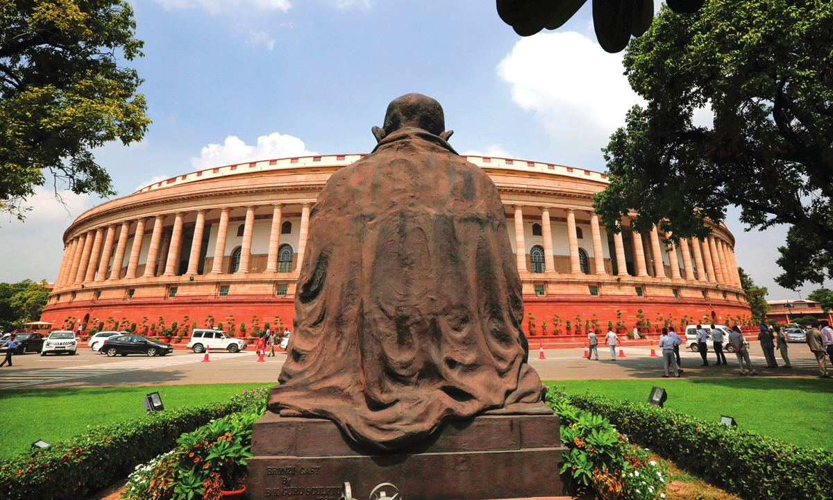 A statue of Mahatma Gandhi overlooks the Indian parliament house Photo: AP