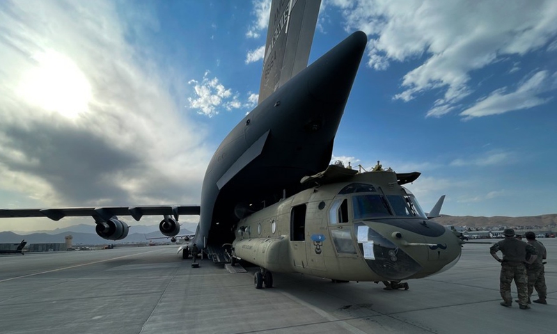 A CH-47 Chinook is loaded onto a U.S. Air Force C-17 Globemaster III at Hamid Karzai International Airport in Kabul, Afghanistan, on Aug. 28, 2021. (U.S. Central Command Public Affairs/Handout via Xinhua)