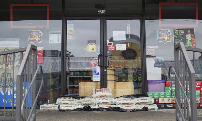 Sandbags are piled up at the door of a supermarket to prevent possible flooding caused by Hurricane Ida in New Orleans, Louisiana, the United States, on Aug. 29, 2021.(Photo: Xinhua)