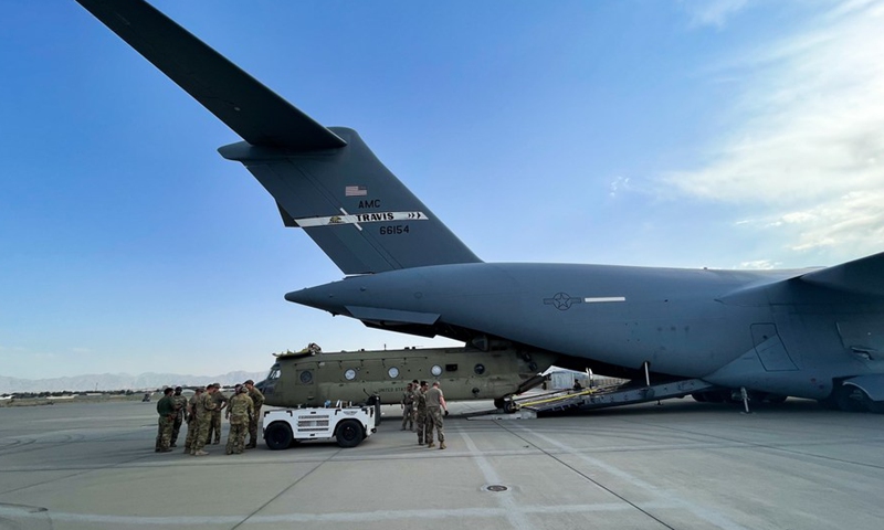 A CH-47 Chinook is loaded onto a U.S. Air Force C-17 Globemaster III at Hamid Karzai International Airport in Kabul, Afghanistan, on Aug. 28, 2021. (U.S. Central Command Public Affairs/Handout via Xinhua)