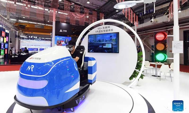 A media professional tries 5G-powered virtual driving during the 2021 World 5G Convention in Beijing, capital of China, Aug. 31, 2021. The 2021 World 5G Convention kicked off here on Tuesday. Photo: Xinhua 