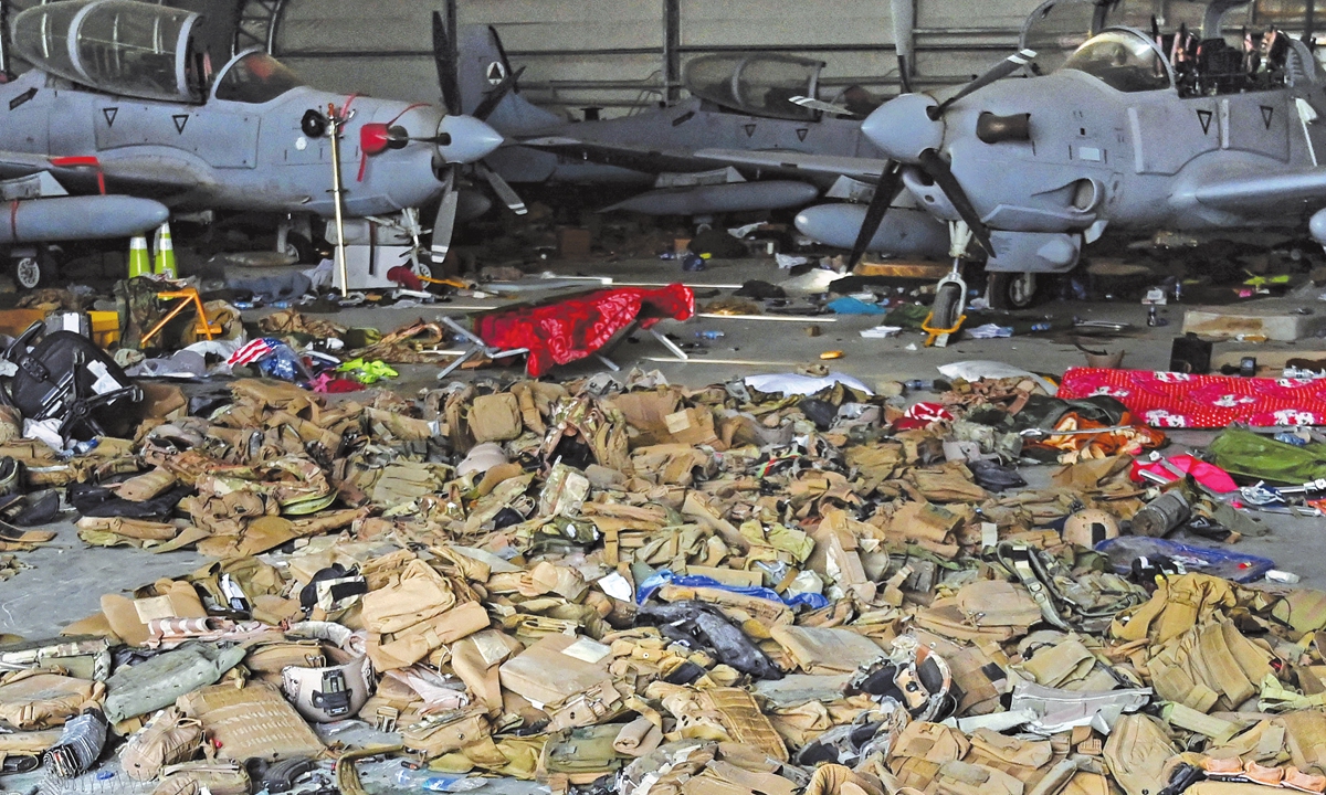 Afghan Air Force’s A-29 attack aircraft are shown as armored vests lie on the ground inside a hangar at the airport in Kabul on Monday after the US pulled all its troops out of the country to end a brutal 20-year war. Photo: AFP 