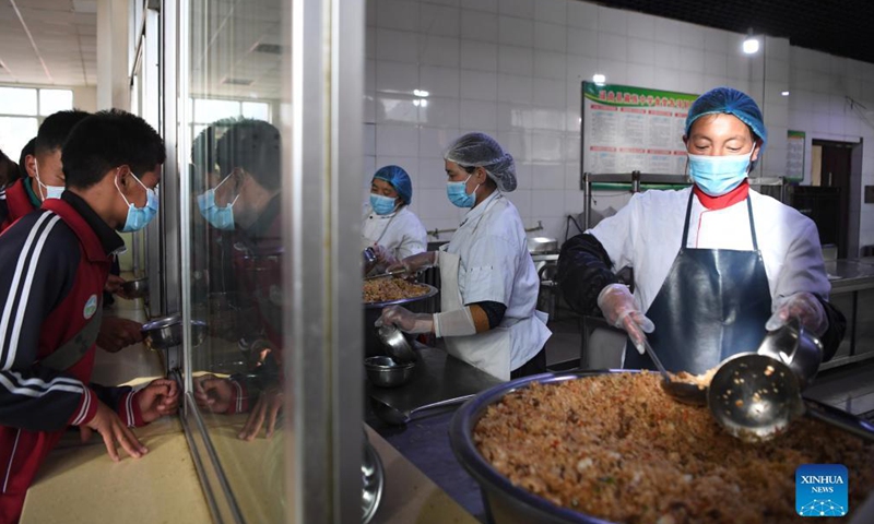 Students get food at the canteen of Luqu Tibetan Middle School in Luqu County, Gannan Tibetan Autonomous Prefecture, northwest China's Gansu Province, Aug. 30, 2021.Photo:Xinhua