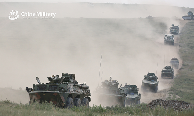 A group of armored vehicles attached to a combined arms brigade under the PLA 81st Group Army maneuver on dirt roads in speed to a designated training base for a tactical test on August 12, 2021. (eng.chinamil.com.cn/Photo by Xue Wei)