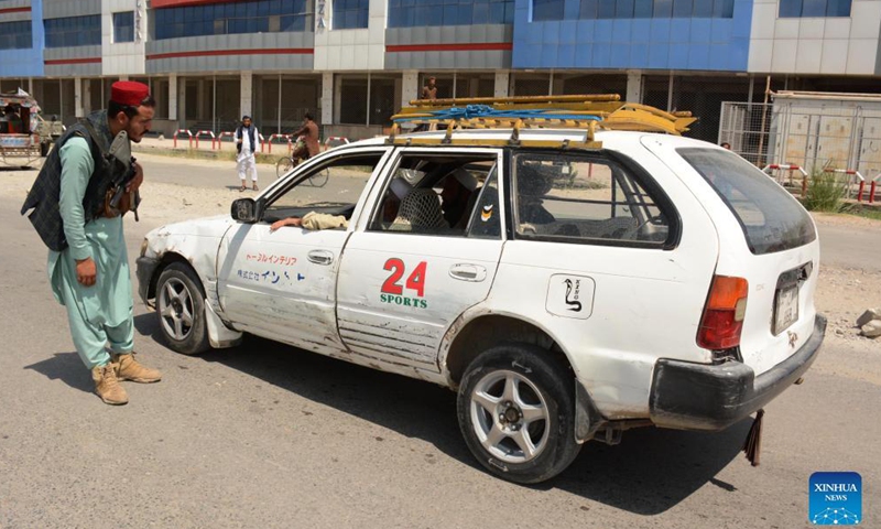 A Taliban member checks a vehicle at a security checkpoint in Jalalabad, capital of Nangarhar province, Afghanistan, Aug. 31, 2021.Photo:Xinhua