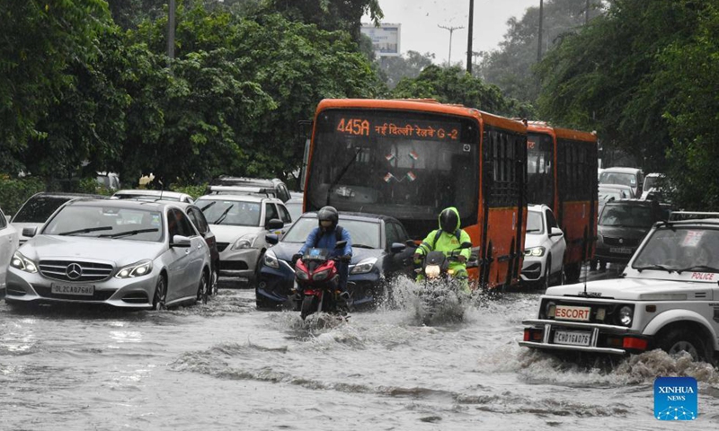 Vehicles move through a water-logged road after a heavy rain in New Delhi, India, Aug. 31, 2021.Photo:Xinhua