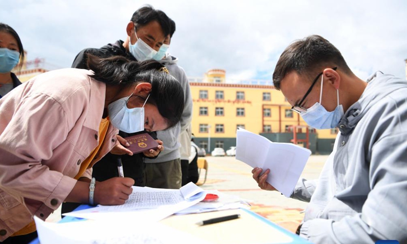 A student of the tenth grade registers her information at Luqu Tibetan Middle School in Luqu County, Gannan Tibetan Autonomous Prefecture, northwest China's Gansu Province, Aug. 30, 2021.Photo:Xinhua