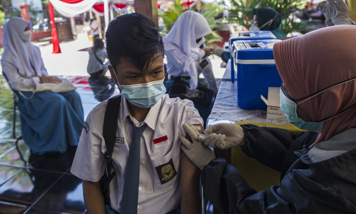 A student receives a shot of the Sinovac COVID-19 vaccine at a high school in Surabaya, Indonesia on Wednesday. Photo: AFP
