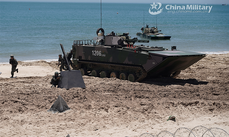 Soldiers assigned to a brigade of the army under the PLA Eastern Theater Command move forward for assault after disembarking from their amphibious infantry fighting vehicle (IFV) during a recent beach raid training exercise. The Army brigade has organized amphibious landing drills on subjects of landing craft ferrying, assault wave formation, beach-landing, obstacle breaking and so on. (eng.chinamil.com.cn/Photo by Zeng Bingyang)