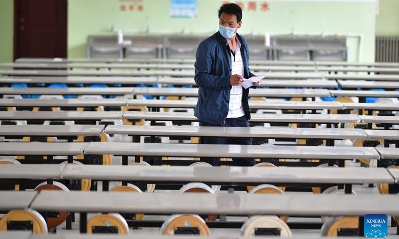 A teacher checks the sanitation condition of student canteen at Luqu Tibetan Middle School in Luqu County, Gannan Tibetan Autonomous Prefecture, northwest China's Gansu Province, Aug. 30, 2021.Photo:Xinhua
