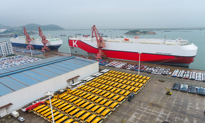 Two large ocean-going freighters load cars for export at a special automobile terminal at Lianyungang Port, East China's Jiangsu Province on Monday. Lianyungang Port opened a green channel this year for vehicle exports to ensure timely shipment. From January to July, 80,252 vehicles were exported at the port, up 71.8 percent year-on-year. Photo: VCG
