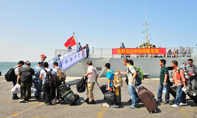 Chinese evacuees lining up to board the frigate Linyi on March 29, 2015.