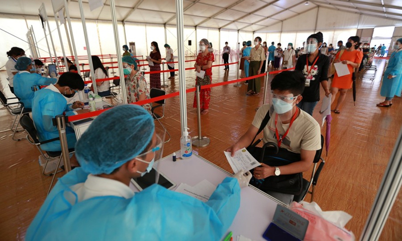 A health worker checks the document of a person before receiving the shot of China's Sinopharm COVID-19 vaccine at Myanmar Chinese Chamber of Commerce's COVID-19 Vaccination Center in Yangon, Myanmar, Sept. 1, 2021.(Photo: Xinhua)