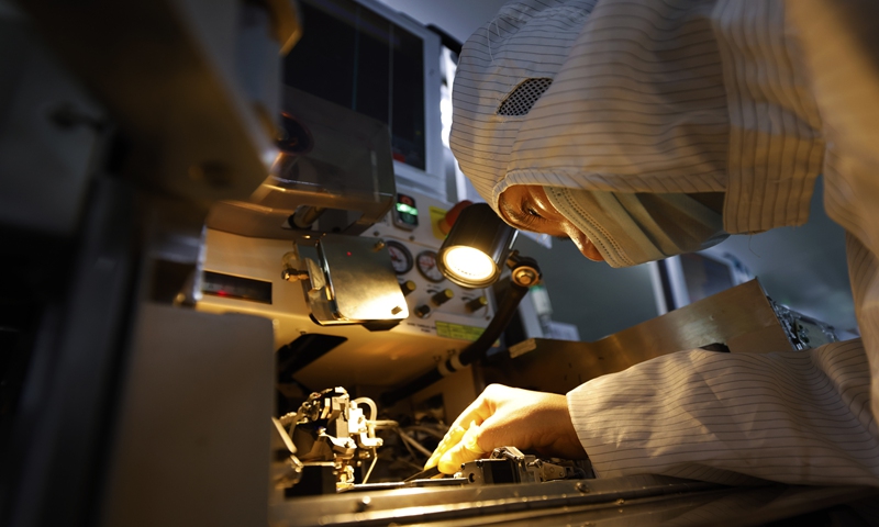 A worker checks a chip product at a factory in the  Sihong Economic Development Zone in Sihong county, East China's Jiangsu Province on Monday. At present, Sihong county has formed electronic information, new materials, mechanical and electrical equipment and other leading industry development clusters. Photo: VCG