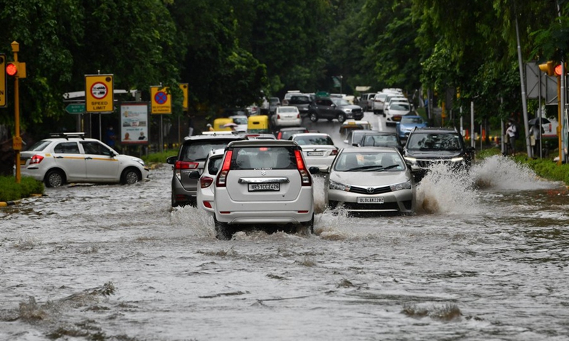 Vehicles moving in a water-logged road after heavy rainfall in New Delhi on Sept. 1, 2021.(Photo: Xinhua)