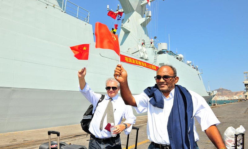 Technical staff of a Chinese company, from Egypt and Romania respectively, taking the frigate Linyi on March 29, 2015.