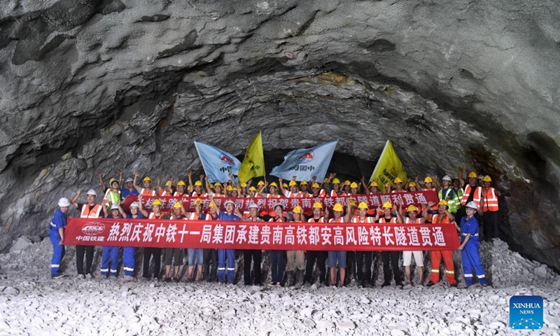 Workers celebrate the drill-through of a railway tunnel in Du'an Yao Autonomous County, south China's Guangxi Zhuang Autonomous Region. Sept. 2, 2021.Photo:Xinhua