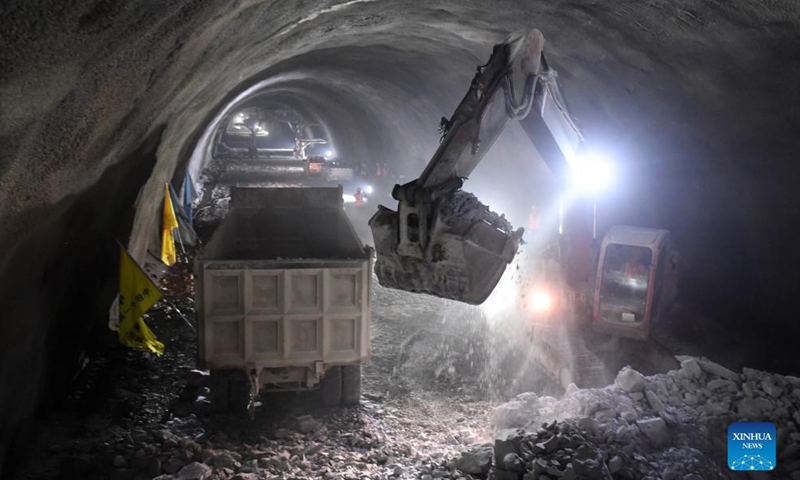 Workers clear a railway tunnel after it was drilled through in Du'an Yao Autonomous County, south China's Guangxi Zhuang Autonomous Region. Sept. 2, 2021.Photo:Xinhua