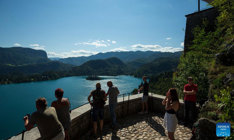 Visitors overlook Bled lake from Bled castle in Slovenia, Sept. 1, 2021. Bled lake is one of the most attractive tourist destinations in Slovenia.Photo:Xinhua