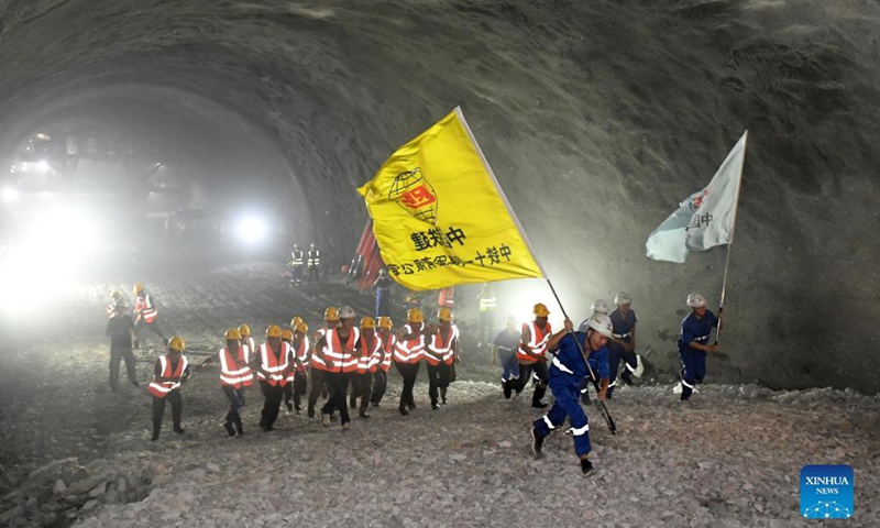 Workers celebrate the drill-through of a railway tunnel in Du'an Yao Autonomous County, south China's Guangxi Zhuang Autonomous Region. Sept. 2, 2021.Photo:Xinhua