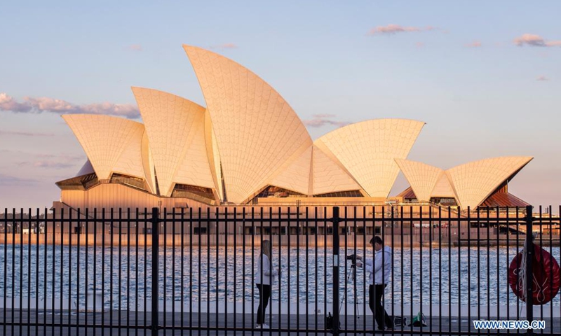 People take photos near Sydney Opera House in Sydney, Australia, Aug. 20, 2021.Photo:Xinhua