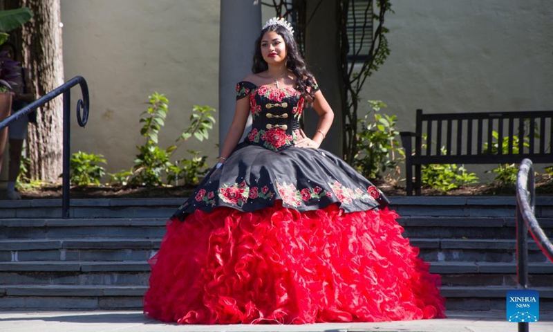 A girl poses for photos during the Quinceanera Fashion Show in Dallas, Texas, the United States, on Sept. 4, 2021. The show was held here Saturday as part of the 4th annual Dallas Arboretum Hispanic Heritage Celebration. (Photo by Dan Tian/Xinhua)