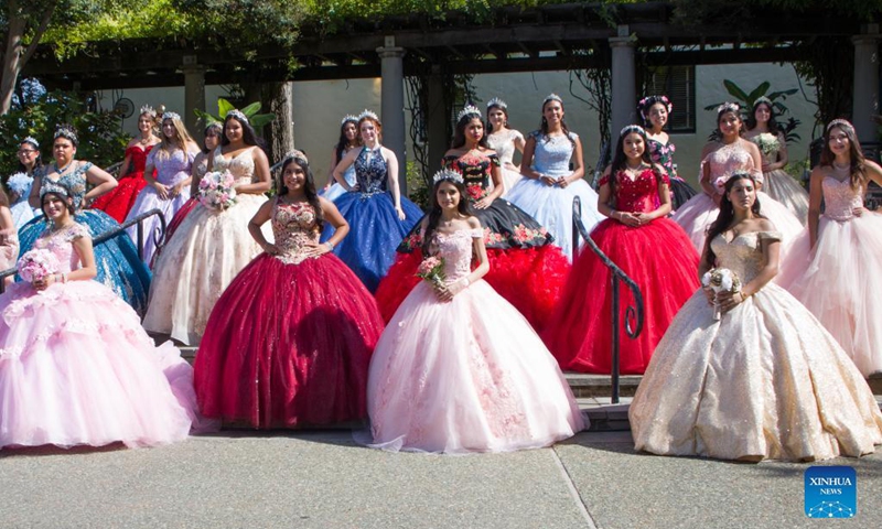 Girls pose for photos during the Quinceanera Fashion Show in Dallas, Texas, the United States, on Sept. 4, 2021. The show was held here Saturday as part of the 4th annual Dallas Arboretum Hispanic Heritage Celebration. (Photo by Dan Tian/Xinhua)