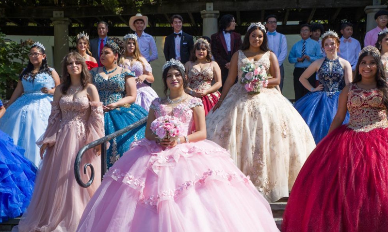 Girls pose for photos during the Quinceanera Fashion Show in Dallas, Texas, the United States, on Sept. 4, 2021. The show was held here Saturday as part of the 4th annual Dallas Arboretum Hispanic Heritage Celebration. (Photo by Dan Tian/Xinhua)