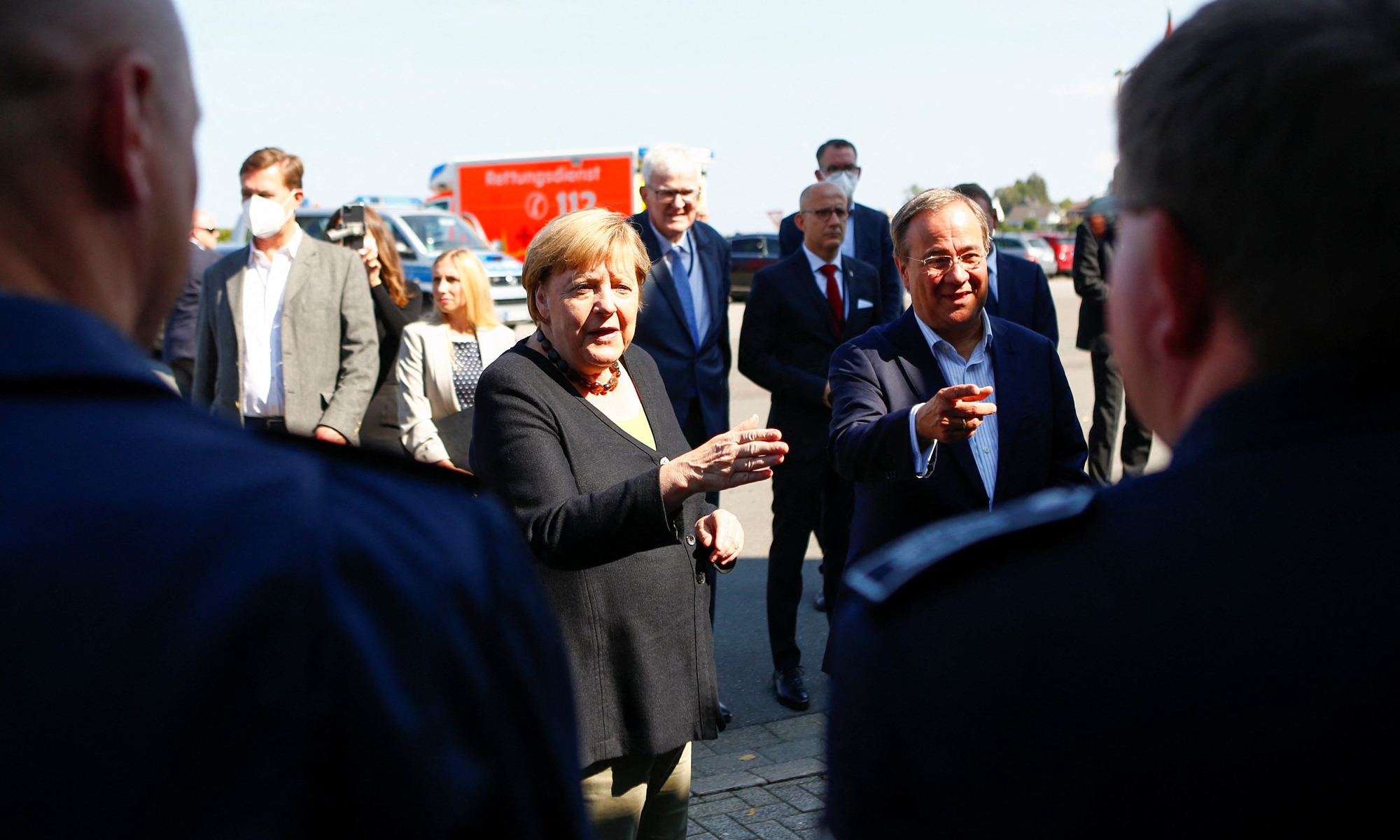German Chancellor Angela Merkel (center) and North Rhine-Westphalia's State Premier and Germany's conservative Christian Democratic Union's chancellor candidate Armin Laschet (right) visit the fire station in Schalksmuehle, North Rhine-Westphalia, western Germany on Sunday, during a tour in the flood-hit region. Since mid July, the floods have caused about 180 deaths in this area. Photo: AFP