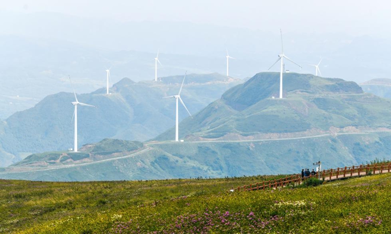 Tourists tour a scenic spot in Hezhang County, southwest China's Guizhou Province, Sept. 3, 2021. Hezhang County, featuring beautiful natural scenery and distinctive culture, has ramped up efforts in improving tourism facilities and boosting tourism industry in recent years. Tourism development of the county has given impetus to its rural revitalization. Statistics show that the county has received 4.34 million visitor trips from January to August this year. (Xinhua/Yang Wenbin)
