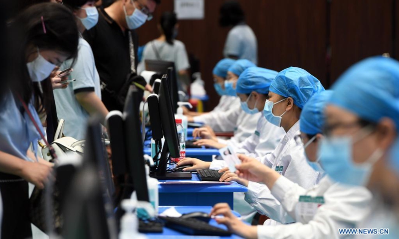 Medical workers record information of the students who are about to receive COVID-19 vaccines at a vaccination site in a middle school in Zhengzhou, central China's Henan Province, Aug. 19, 2021. Zhengzhou recently started COVID-19 vaccination for minors aged between 12 and 17.