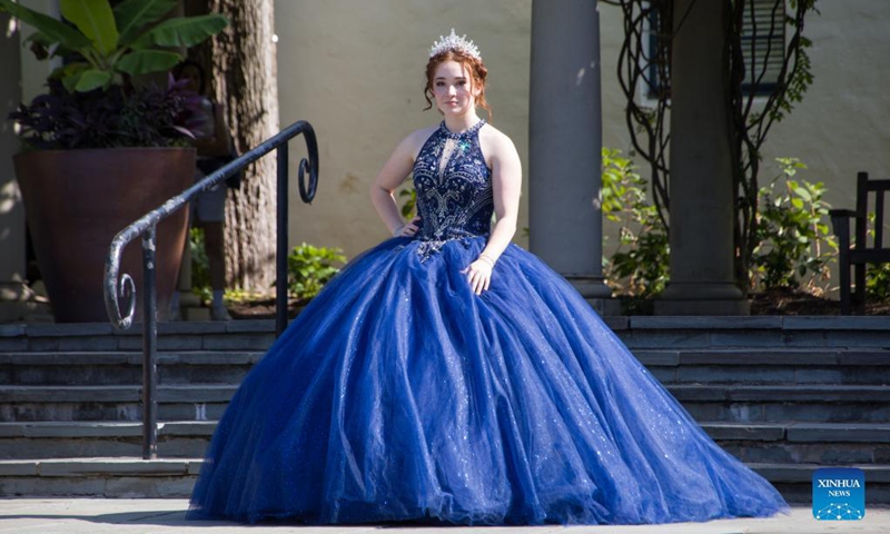 A girl poses for photos during the Quinceanera Fashion Show in Dallas, Texas, the United States, on Sept. 4, 2021. The show was held here Saturday as part of the 4th annual Dallas Arboretum Hispanic Heritage Celebration. (Photo by Dan Tian/Xinhua)