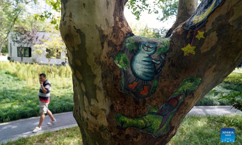 Painted tree holes are seen at Zhabei Park in Shanghai, east China, Aug. 31, 2021. Zhabei Park recently made an effort to improve its appearance by cleaning and beautifying tree holes in the park with creative patterns. (Xinhua/Wang Xiang) 