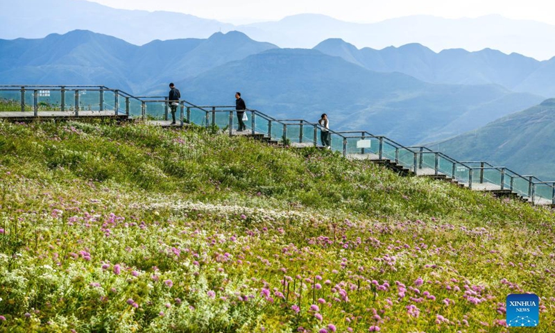 Tourists visit a scenic spot in Hezhang County, southwest China's Guizhou Province, Sept. 3, 2021. Hezhang County, featuring beautiful natural scenery and distinctive culture, has ramped up efforts in improving tourism facilities and boosting tourism industry in recent years. Tourism development of the county has given impetus to its rural revitalization. Statistics show that the county has received 4.34 million visitor trips from January to August this year. (Xinhua/Yang Wenbin) 