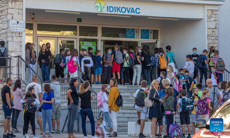 Children arrive at a school on the first day of a new school year in Pula, Croatia, on Sept. 6, 2021. Some 460,000 children went back to school in Croatia on Monday, as the country eased measures introduced to tackle COVID-19.(Photo: Xinhua)